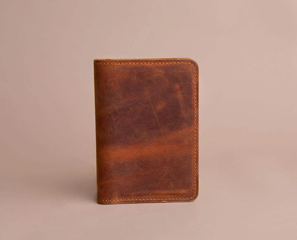 Camel Color leather wallet on a beige background